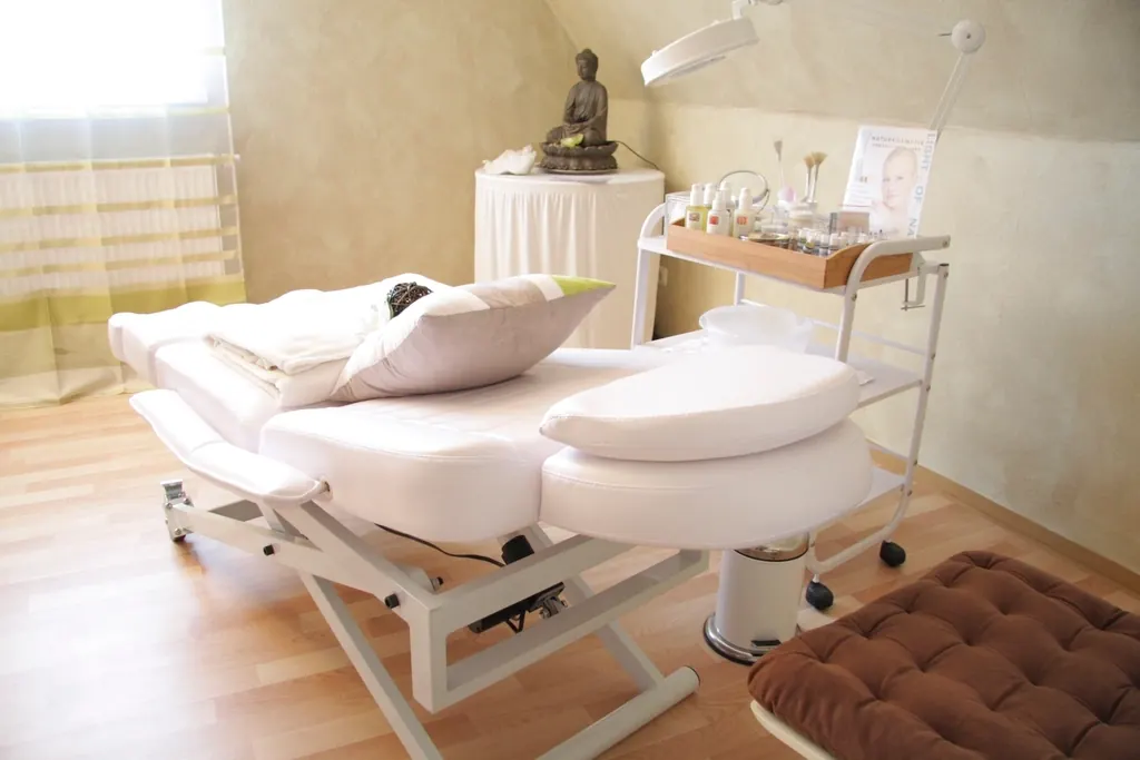 A calm treatment room with a made-up facial bed