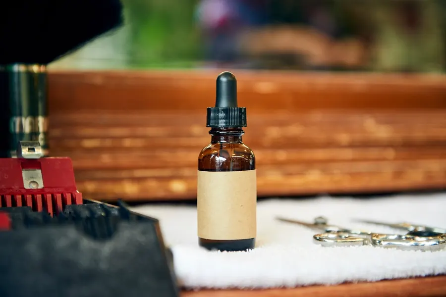 An amber serum dropper bottle on a wooden tray